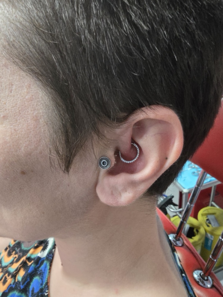 Daith ear piercing with a jewelled ring