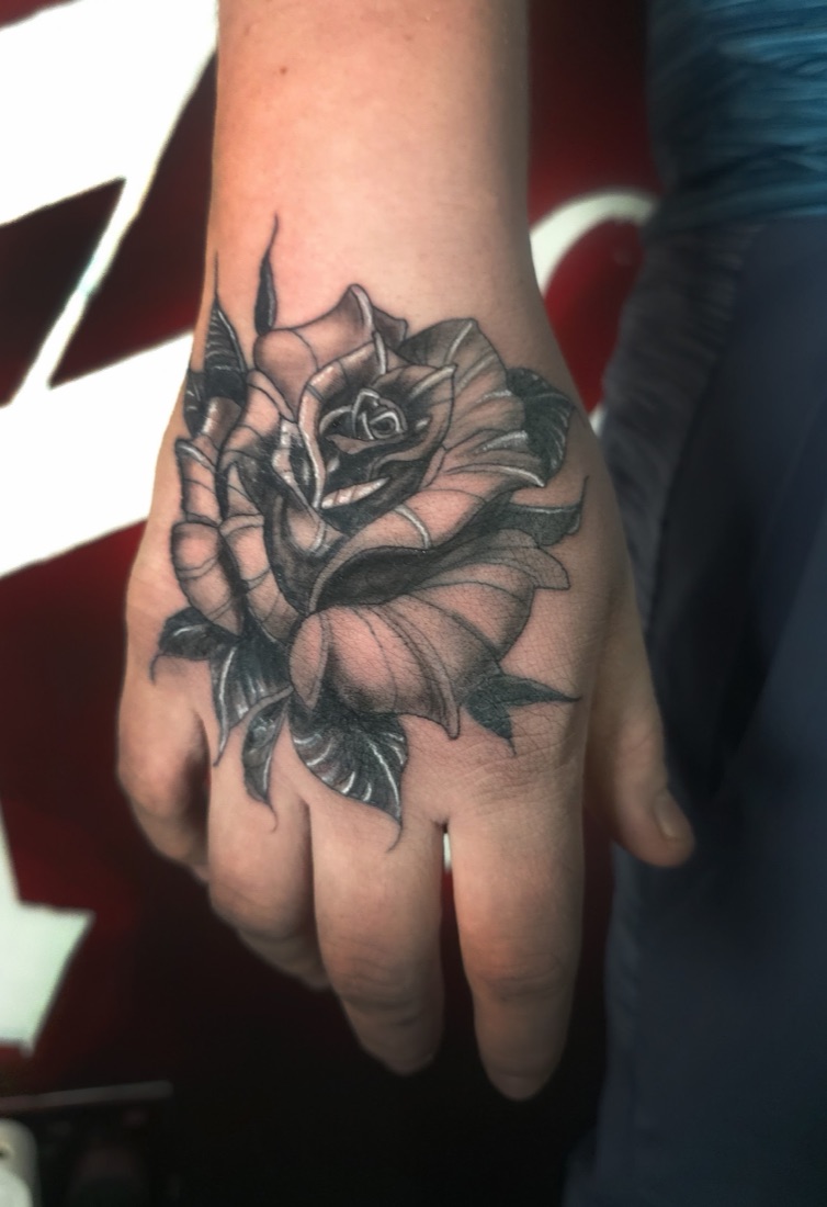 Black and grey realism rose tattoo on the hand